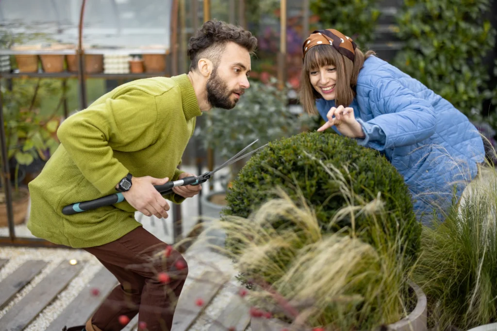 young-couple-prune-a-round-bush-with-scissors-in-g-2025-04-02-17-46-12-utc 1